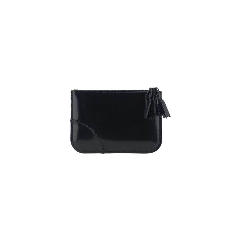 Comme des Garçons black leather coin purse with top zipper closure and signature logo, shiny finish.