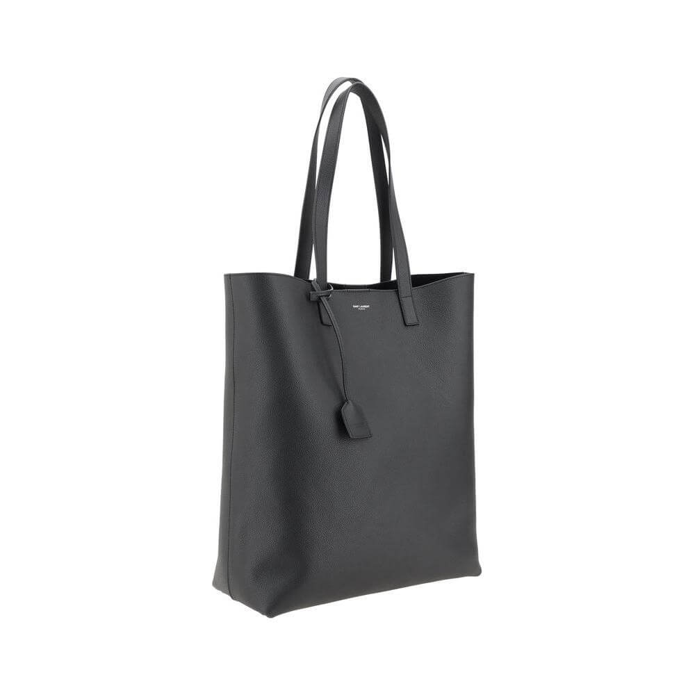 Saint Laurent black leather tote bag with grained texture, top handles, and monogram detail.