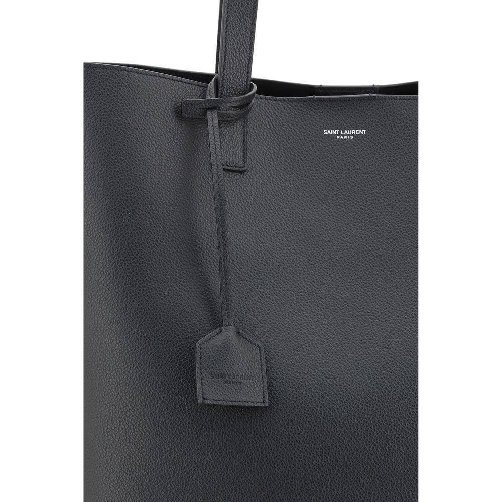 Saint Laurent hammered leather tote bag with grained design and monogram, featuring top handles for versatile carrying.