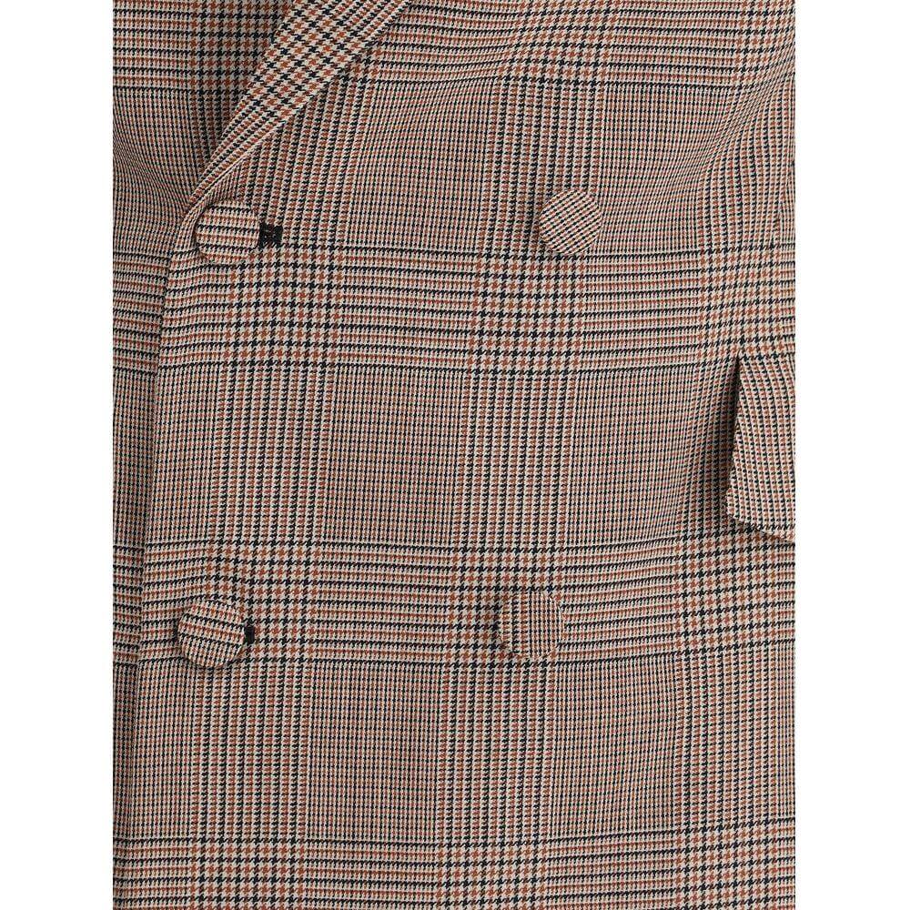 Close-up of Alexander McQueen wool blazer with check pattern, peaked lapel, and double-breasted closure.