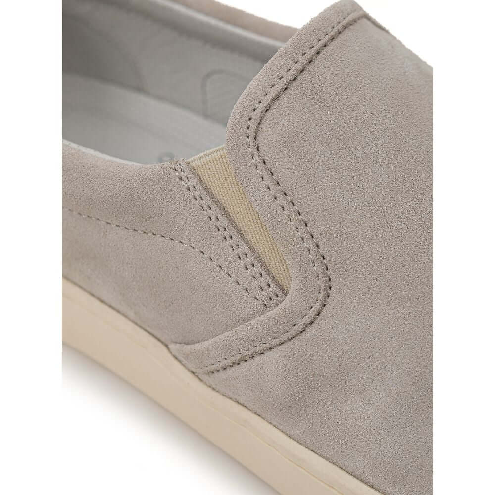 Brunello Cucinelli gray leather slip-on sneaker with white rubber sole and black detail featuring gold 'Solomei' micro print.