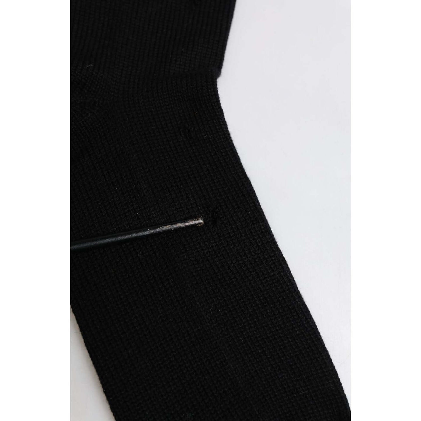 Dolce & Gabbana black mid calf men's socks with minor defect, featuring holes. Genuine Italian-made accessory with logo details.