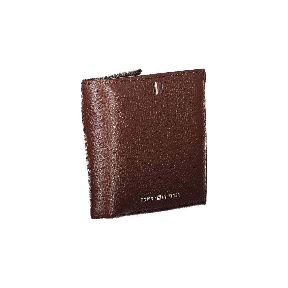 Tommy Hilfiger brown leather bifold wallet with logo detailing, featuring two compartments and a coin purse for stylish organization.