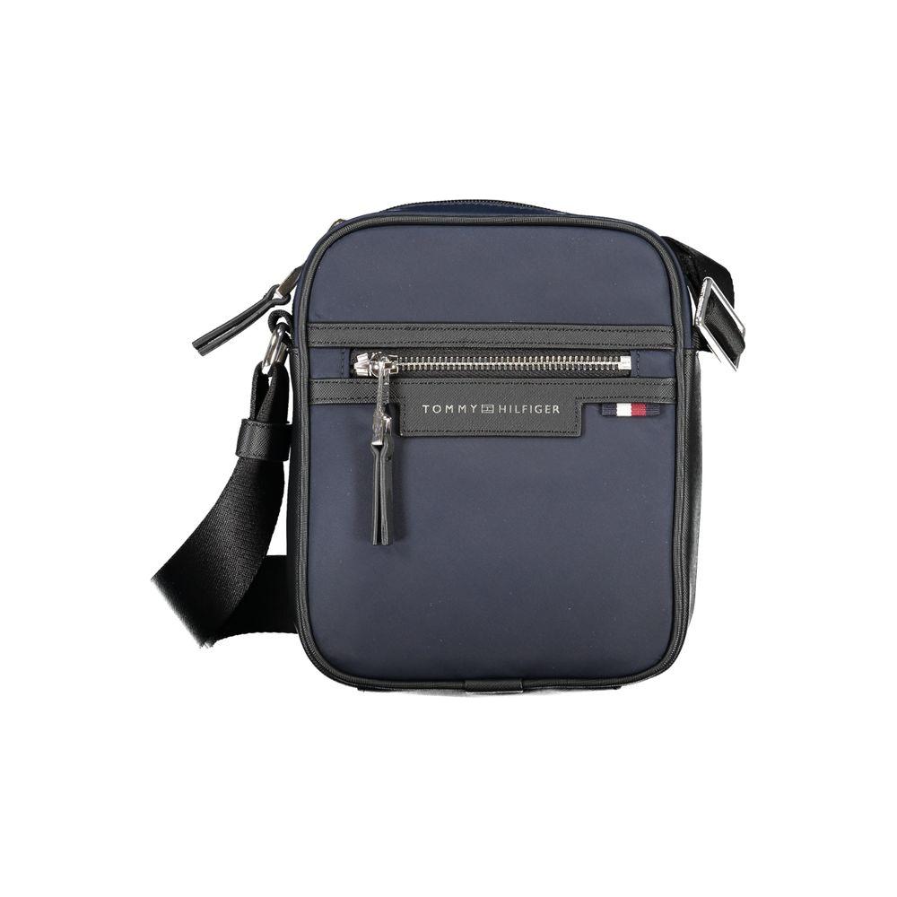 Tommy Hilfiger blue polyester shoulder bag with adjustable strap, zip closure, logo, and pockets. Made from 50% recycled materials.