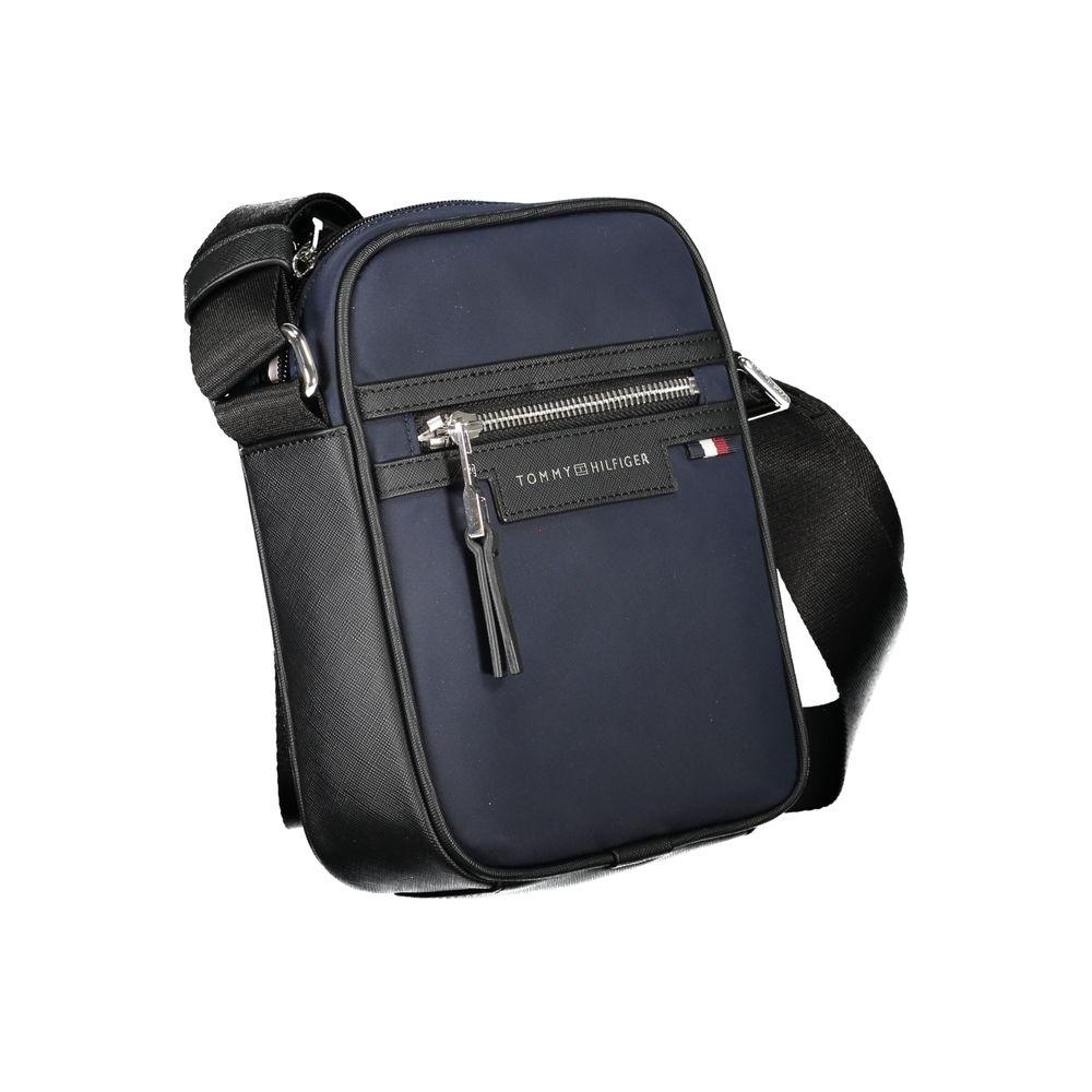 Tommy Hilfiger blue polyester shoulder bag with adjustable strap, external zip pocket, logo detail, made from 50% recycled material.