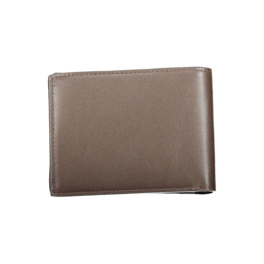 Calvin Klein brown leather wallet with RFID block, featuring two compartments, coin purse, and spaces for cards, displaying logo.